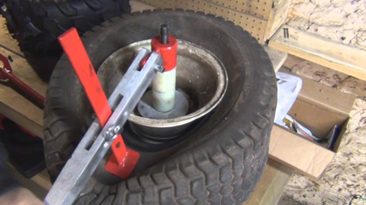 putting on a small tractor tire with manual tire machine