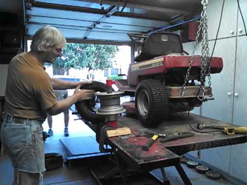 putting on a small tractor tire with manual tire machine